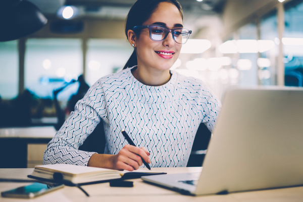 Female With Glasses Researching Online Degrees